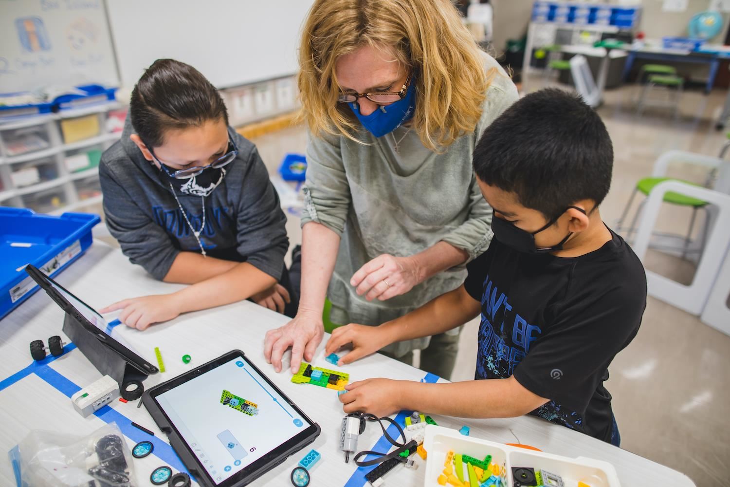 Teacher Helping Students in Classroom
